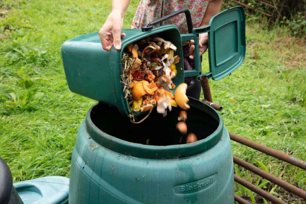 Emptying food waste into the compost bin